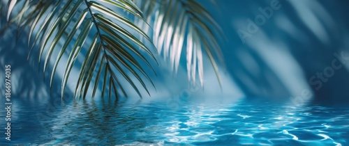 Blurred palm leaf shadows on a blue water background, a summer banner template with copy space for text