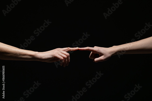 Wallpaper Mural Two outstretched hands gently connect at the fingertips, evoking a sense of creation, unity, or intimacy against a deep black background with copy space Torontodigital.ca