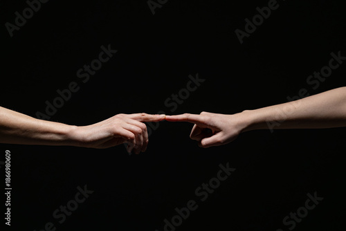 Wallpaper Mural Two outstretched hands gently connect at the fingertips, evoking a sense of creation, unity, or intimacy against a deep black background with copy space Torontodigital.ca