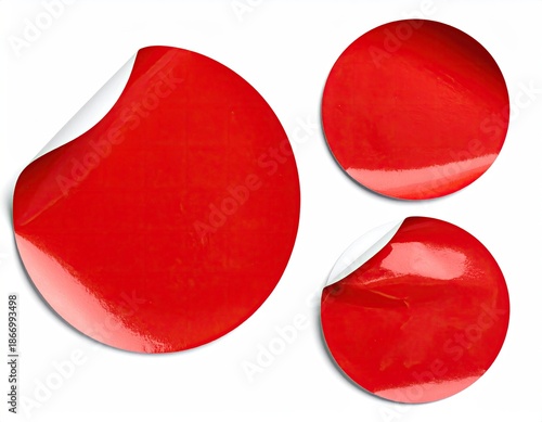 Three red circular stickers, some peeled