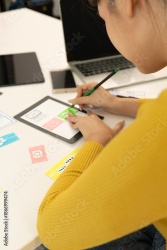 Creative web designer planning UI application and developing digital template