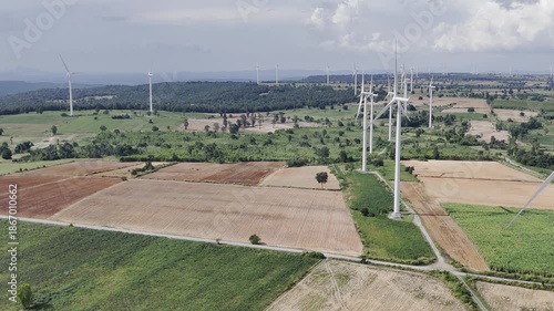 Wind turbines at green mountain hill clean sustainable electricity power, Green generator cloud blue sky fly over with drone shot