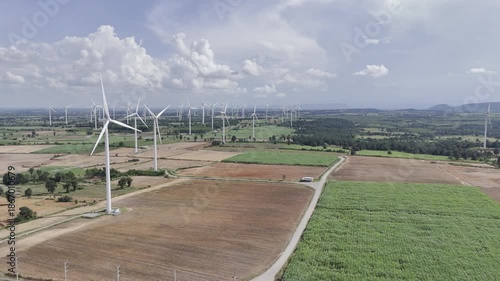 Wind turbines at green mountain hill clean sustainable electricity power, Green generator cloud blue sky fly over with drone shot