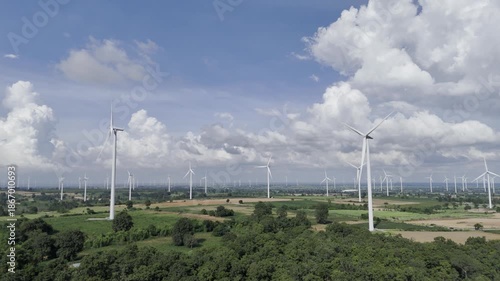Wind turbines at green mountain hill clean sustainable electricity power, Green generator cloud blue sky fly over with drone shot
