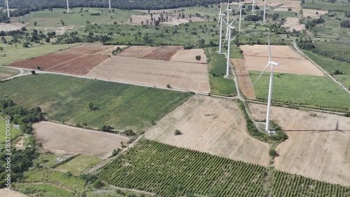Wind turbines at green mountain hill clean sustainable electricity power, Green generator cloud blue sky fly over with drone shot