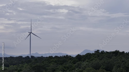 Closeup beautiful solo wind turbine at green mountain hill clean sustainable electricity power, Green generator cloud blue sky