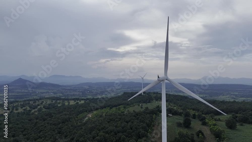 Closeup beautiful solo wind turbine at green mountain hill clean sustainable electricity power, Green generator cloud blue sky