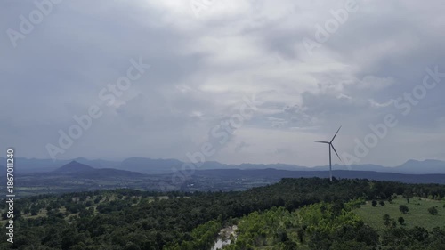 Closeup beautiful solo wind turbine at green mountain hill clean sustainable electricity power, Green generator cloud blue sky