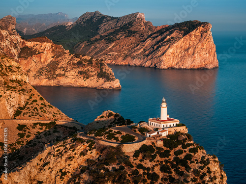 Mallorca, Spain - Aerial view of the Lighthouse at Cap de Formentor at sunrise with amazing cliffs and clouds and blue sky at background