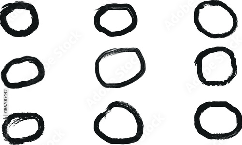 A collection of nine irregular black circles on a white background