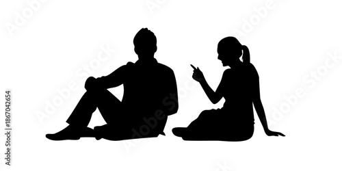 Silhouette of two people engaged in conversation