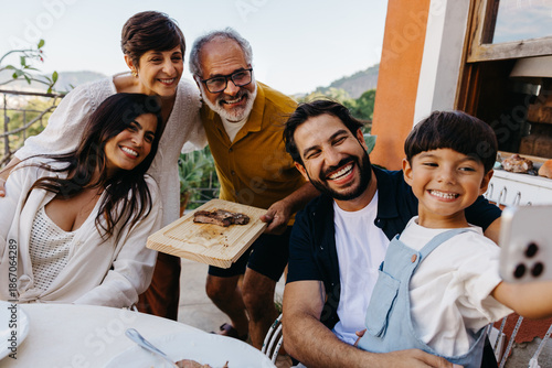Tableau sur toile Family enjoying churrasco together during an outdoor lunch gathering