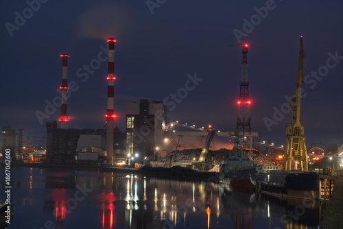 The combined heat and power plant at night, reflected in the water