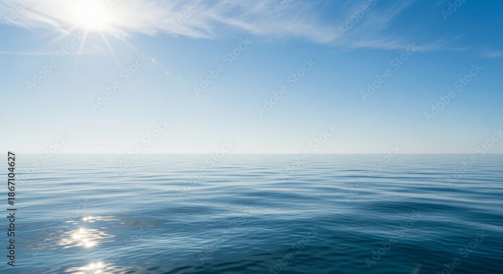Obraz premium Endless Horizon: Capturing the vastness and serenity of the open sea under a bright, cloudless sky, with the sun's radiant rays adding a touch of brilliance. This image is about peace and tranquility.