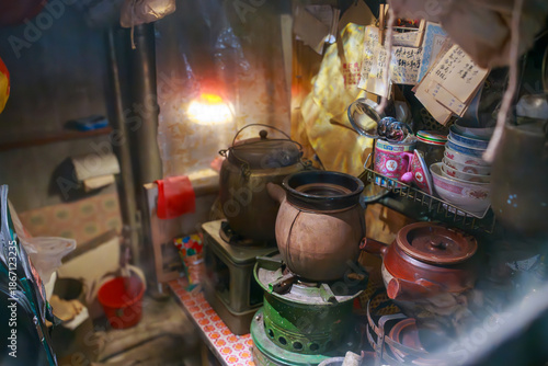 Traditional medicine cooking in a clay pot at a 1980s Hong Kong herbal shop.