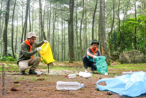 Two Volunteers Cleaning up Plastic Waste in Stunning Forest