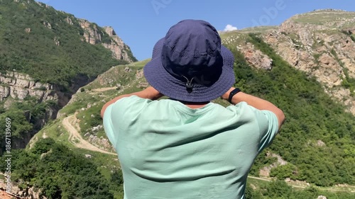man making picture panorama mountains amateur mobile phone