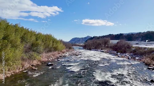 Aerial view of the majestic Tone River flowing through a snowy landscape