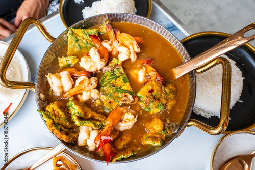 Acacia leaf omelet and shrimp in spicy sour soup and rice on plate, Thai food. Image on top view.