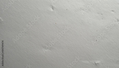 Close-up of smooth gray sand surface with footprints