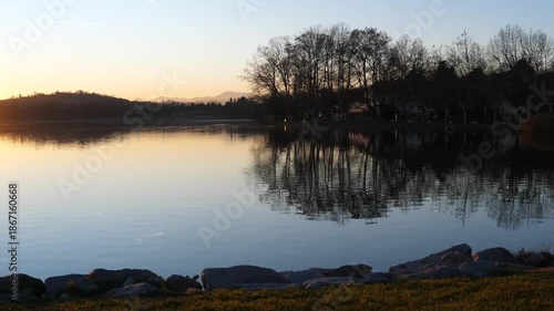 A beautiful and panoramic view of the Varese lake during sunset. An italian landscape in winter. Varese, Italy - December 29, 2025 