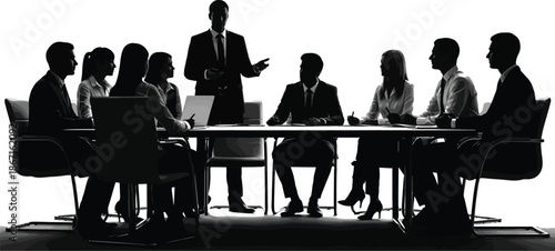 Silhouette of a confident business leader standing and gesturing while presenting important strategic plans to a diverse group of executives seated around a conference table during a formal meeting