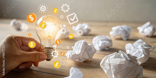 Creative Marketing Strategy. Hand holding a lit light bulb representing business ideas and financial investment with creative business thinking