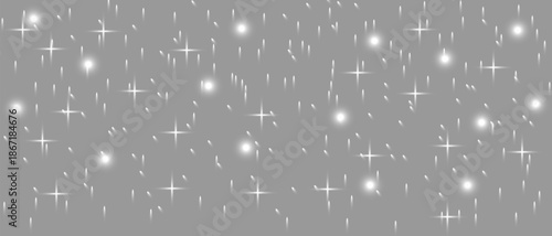 A shimmering array of bright white stars and particles on a soft gray background creating a sparkling effect