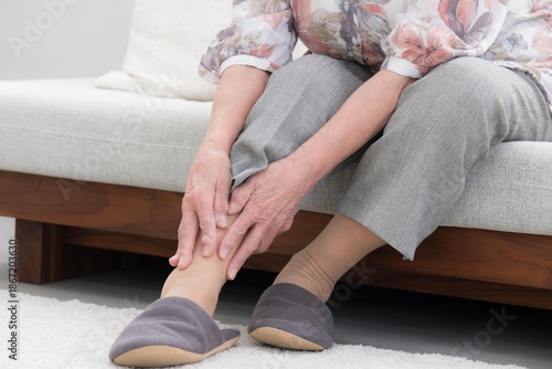 Tableau sur toile An image of ankle pain and joint pain in the elderly,without face