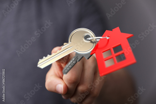 Person's hand holding house...