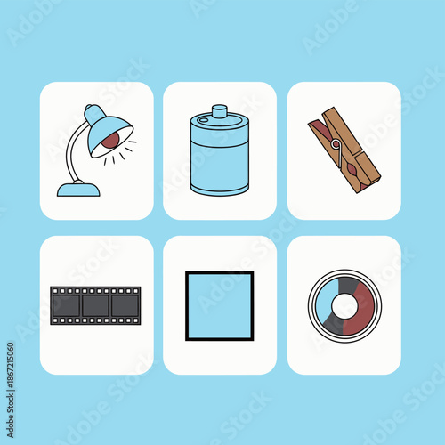 Vintage analog photography darkroom equipment set with desk lamp, chemical developing tank, wooden clothespin, 35mm film strip, square photo frame and a photographer color wheel