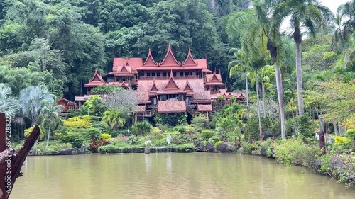 Uthai Thani, Thailand - October, 21, 2025 : Wat Tham Khao Wong, Beautiful wooden house style temple built in the middle of nature between mountain and lake, famous place for tourist.
