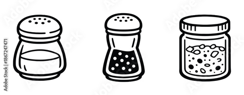 Black and white salt and pepper shakers with spice jar on gray background