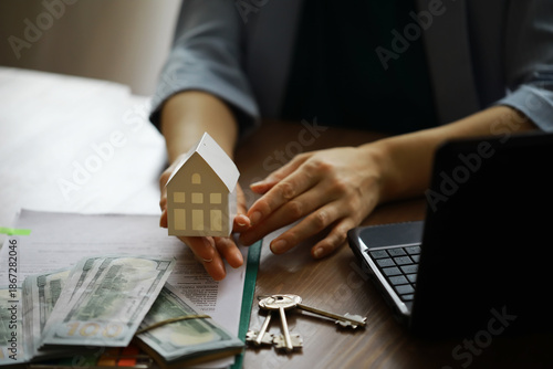 Real estate agent talked the terms of the home purchase agreement and asked the customer to sign the documents, Home sales and insurance concept. © alexkich
