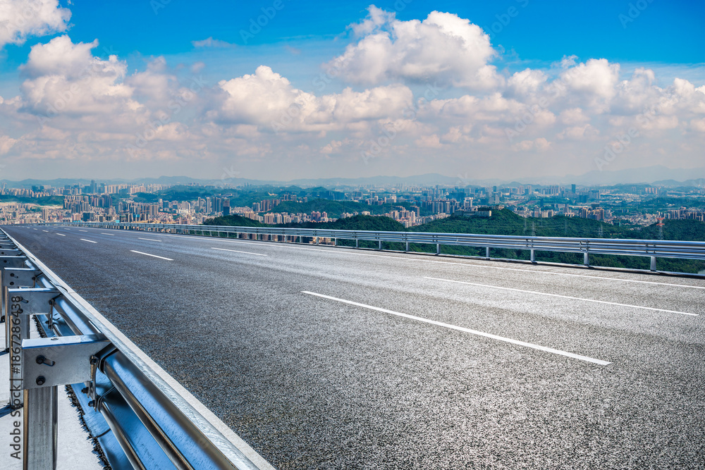 Fototapeta premium Empty asphalt road and city skyline with mountain landscape in Shenzhen