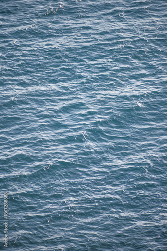 Sparkling Deep Blue Mediterranean Sea Surface with Rippling Waves and Sunlight Reflections
