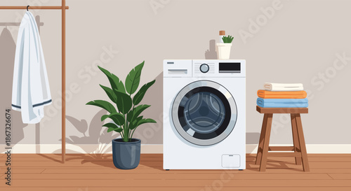 A cozy and modern laundry room interior featuring a front-load washing machine, a houseplant, and neatly folded towels, bathed in soft, natural light.