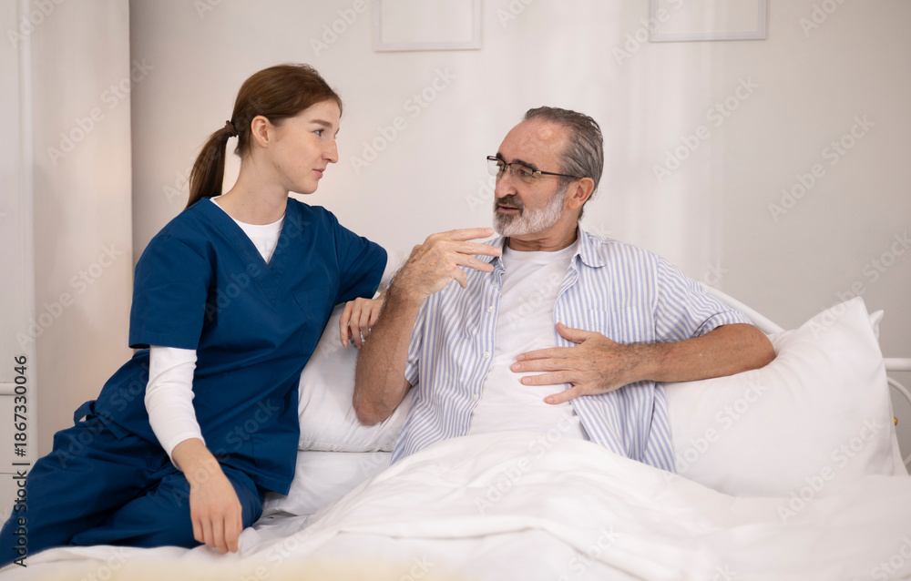 Fototapeta premium A woman or medical caregiver is speaking with an elderly man to seek advice or assistance regarding elderly care.