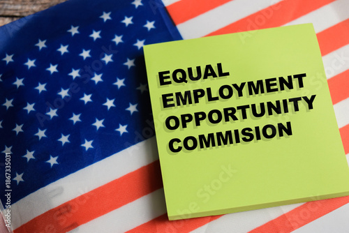 Schilderij op canvas Concept of equal employment opportunity commission and USA flag write on sticky notes isolated on Wooden Table