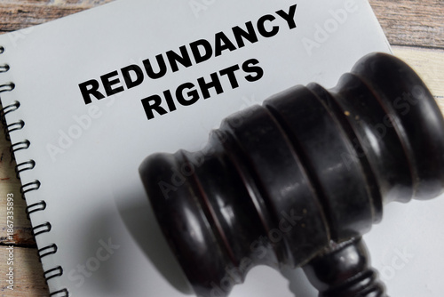 Concept of redundancy rights write on book isolated on Wooden Table.