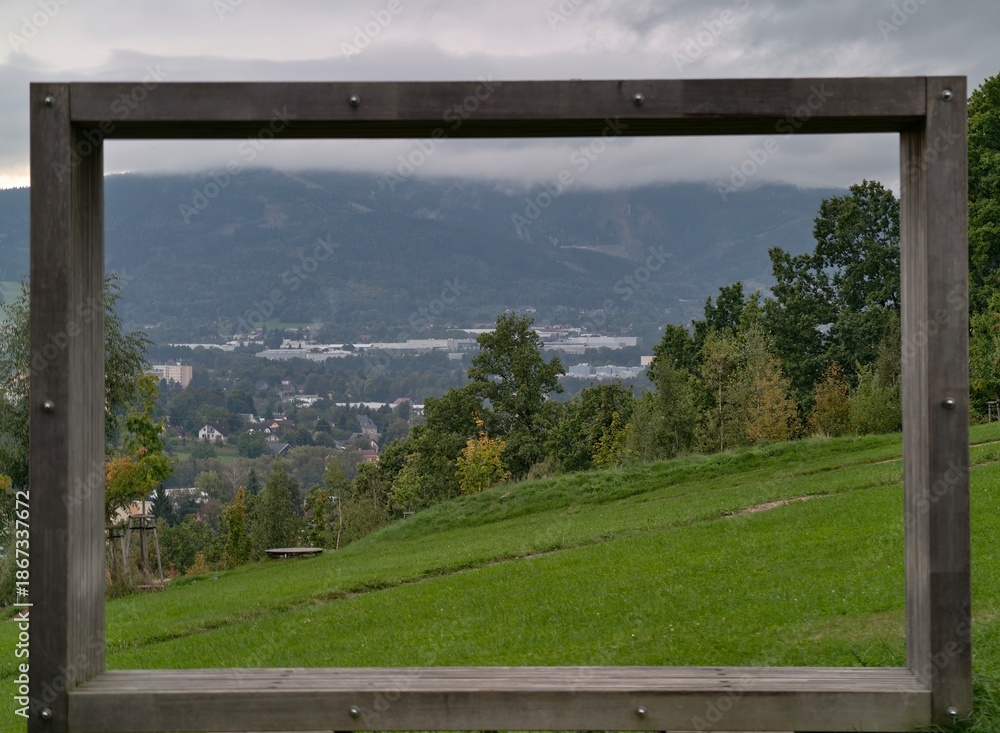 Fototapeta premium peaceful valley with distant settlements, serene alpine scenery with layered mountain silhouettes