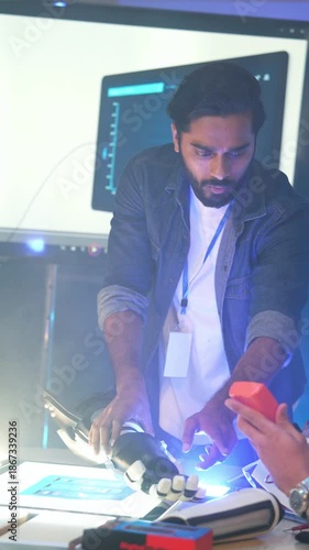 Project manager explaining robotic arm operations during a technical presentation. Professional engineer demonstrating automated prosthetic technology and artificial intelligence at the meeting