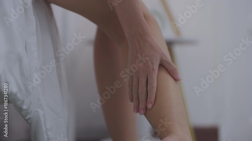 Woman Massaging Her Calf Due to Muscle Pain