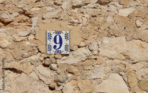 House facade house wall built with natural stone with house number 9