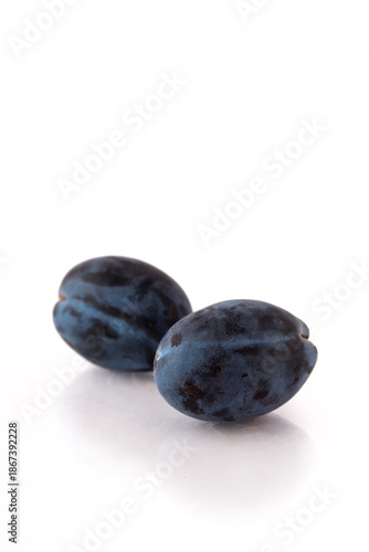 Blue plum isolated on white background with copy space for your text.