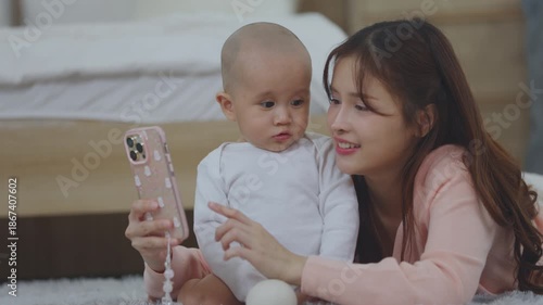 Happy Mother and Baby Interact with Mobile Phone at Home