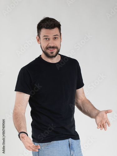 The extrovert psycho type. Handsome Caucasian 35 years old man in black T-shirt looks honesty and candor.