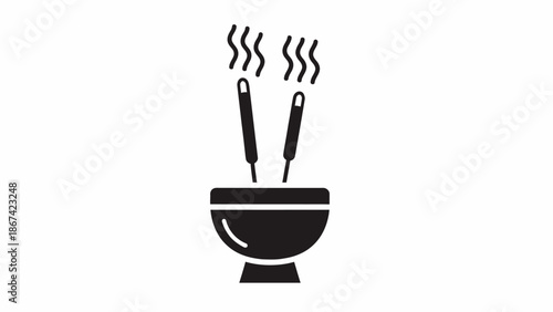 Black bowl with kitchen utensils inside.