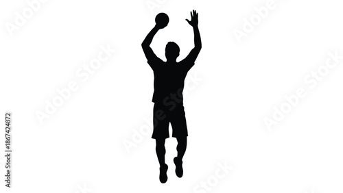 Silhouette of a basketball player in mid air preparing to shoot