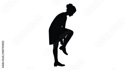 Silhouette of a woman bending down tying her shoe in profile